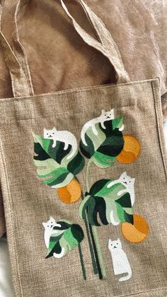 a bag with cats and leaves on it