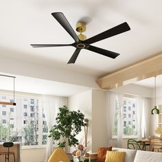 a living room with a couch, table and ceiling fan in the middle of it