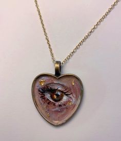 Lover's eye pendants are an Edwardian tradition of having or wearing one's sweetheart's eye painted on canvas. My lover's eye pendants are hand-painted upon order, done in acrylic and varnished to protect them from wear. I recommend avoiding exposure to water while wearing them, just to be on the safe side. Chains are 18" but can be adjusted. When you order, send a photo or photos to my messages, or email me at rachelkiiid@gmail.com with any additional notes on your order (whether you'd like gold/silver leaf, specifications about depicting makeup, etc." I do cat/dog eyes as well! You do not need to have a lover for your lover's eye, you can always love yourself or your friend! My Messages, Lovers Eyes, Miniature Portraits, Eye Painting, Custom Hand Painted, Eye Ring, Eye Jewelry, Eye Necklace, Silver Leaf