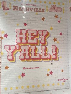 there is a sign that says hey y'all on the wall