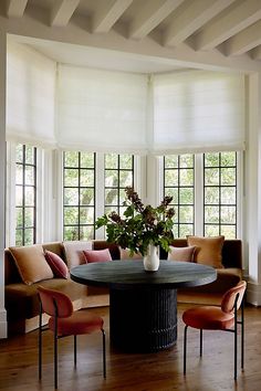 a living room filled with furniture and lots of windows