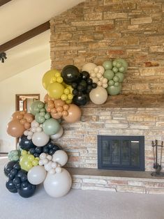 there is a bunch of balloons in front of the fireplace