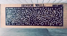 a brick wall with writing on it that says senior wall