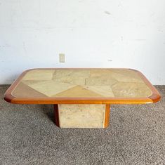 a wooden table sitting on top of a carpeted floor next to a white wall