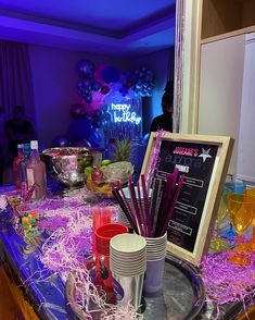 a party table with drinks and decorations on it