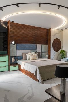 a bedroom with a bed, dressers and lamps on the ceiling is lit by round lights