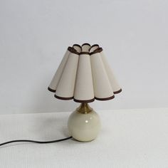 a table lamp sitting on top of a white surface