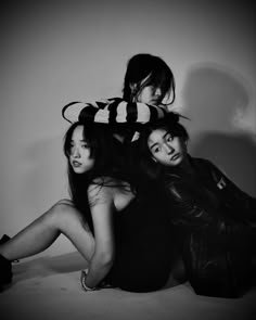 three young women are posing for a black and white photo with their arms around each other