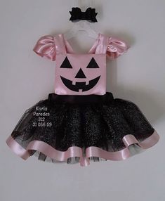 a pink and black dress with a pumpkin on it