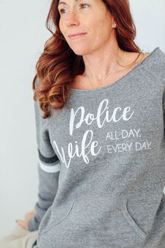 a woman wearing a sweatshirt that says peace we're all day, every day