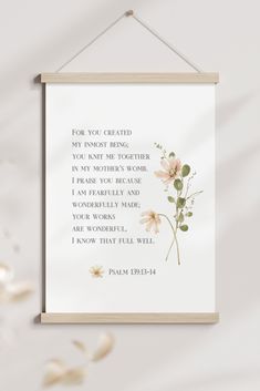 a framed poster hanging on a wall with flowers