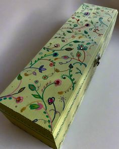 a yellow box with floral designs on it