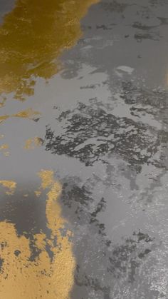 the reflection of an umbrella on the wet surface of water with yellow and gray colors