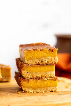 three pieces of cake sitting on top of a wooden cutting board next to each other