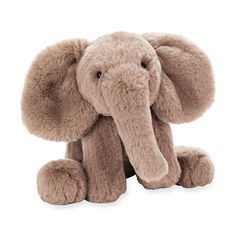 an elephant stuffed animal sitting up against a white background