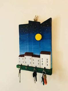 there is a key holder with houses on it