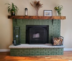 a living room with a fire place and potted plants on top of the fireplace