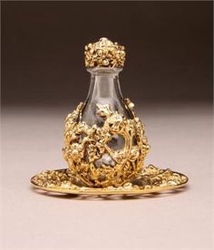 an ornately decorated glass bottle and saucer