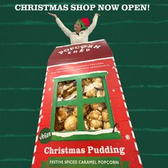 a woman standing on top of a christmas pudding machine with her arms in the air