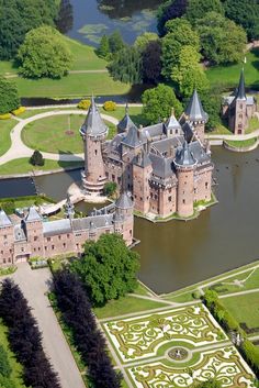 an aerial view of a castle in the middle of a lake