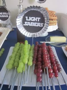 there are many different types of food on the table with lights sabers sign above them