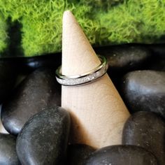 a stack of rocks with a ring on top