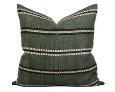 a green pillow with black and white stripes on the front, sitting against a white background