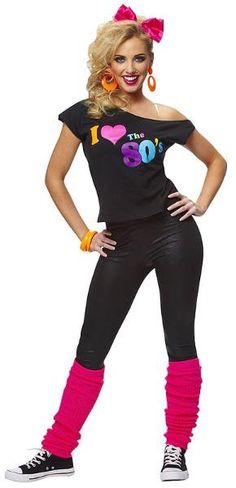 a woman in a black shirt and pink leggings is posing for the camera