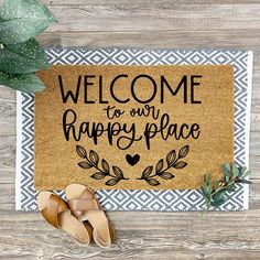 a welcome mat that says welcome to our happy place with sandals on the floor next to it