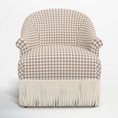 a brown and white checkered chair with fringe trim