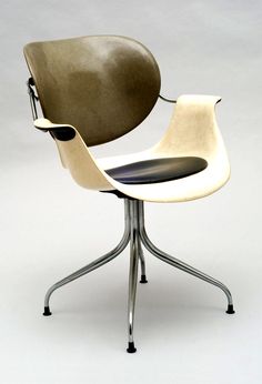 an office chair with a leather seat and metal base, designed by arne moller