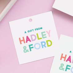 two gift tags with the words handley and ford on them next to a cup of coffee