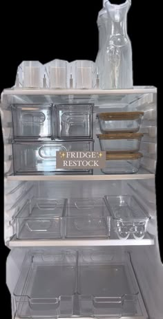 an open refrigerator filled with lots of plastic containers