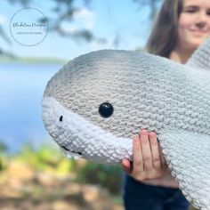 a woman holding a stuffed animal in front of her face