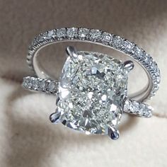 a cushion cut diamond ring with pave set shoulders