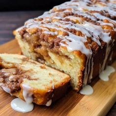 a loaf of cinnamon bread with icing on a cutting board