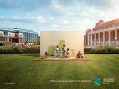 three people sitting at a picnic table in the middle of a grassy area with two buildings behind them