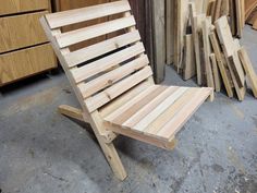 a wooden chair sitting next to stacks of wood