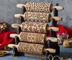 a stack of wooden rolling wheels on top of a blue cloth covered table next to other items