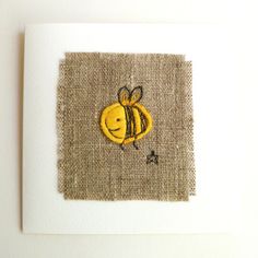 a small card with a yellow bee on it