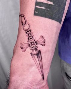 a person with a tattoo on their arm holding a knife