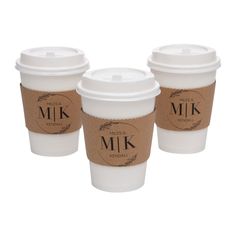 three coffee cups with lids and labels on them