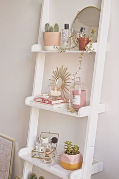 a white shelf filled with lots of different types of items on top of each other