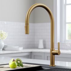 a kitchen sink with an apple and knife on the cutting board in front of it