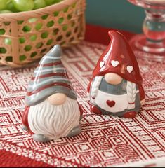 two gnome figurines sitting on top of a table