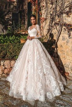 a woman in a wedding dress standing outside