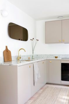 a kitchen with beige cabinets and white counter tops