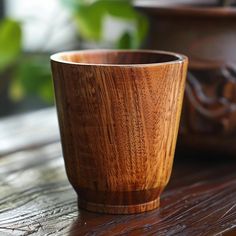 a wooden cup sitting on top of a wooden table