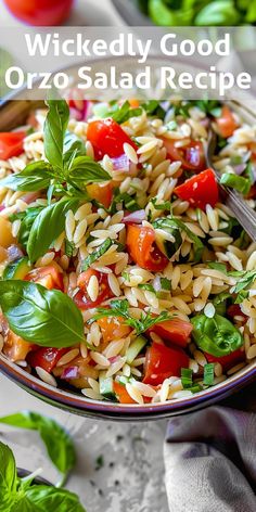 a close up of a bowl of rice salad with tomatoes and spinach on the side