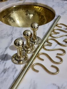 a bathroom sink with gold faucets on it